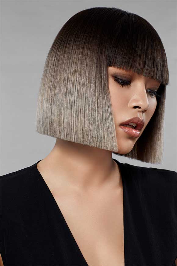 A woman with a box bob with bangs and the Style Masters™ products used to create the look