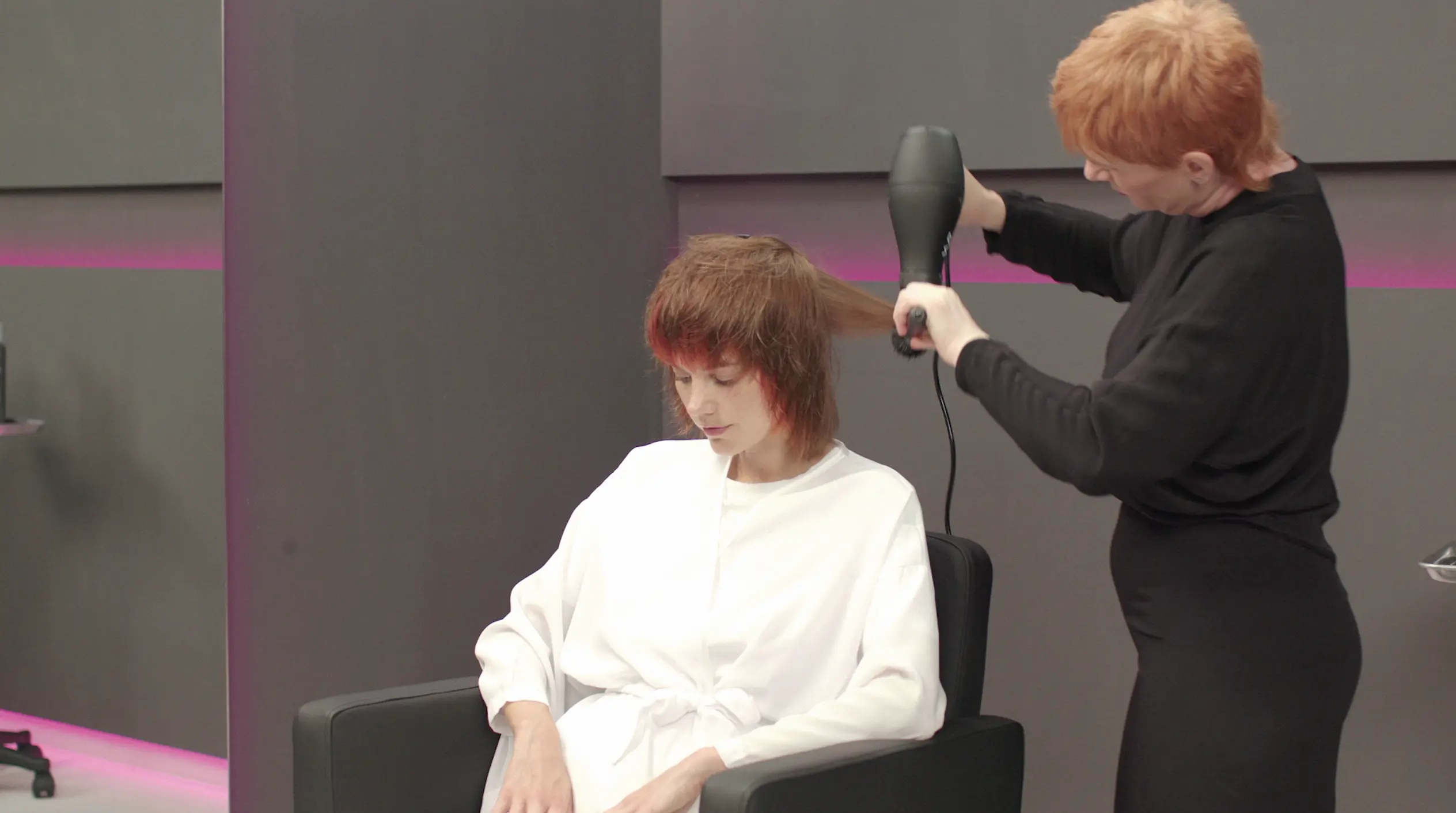 Hairdresser shaping a mullet haircut